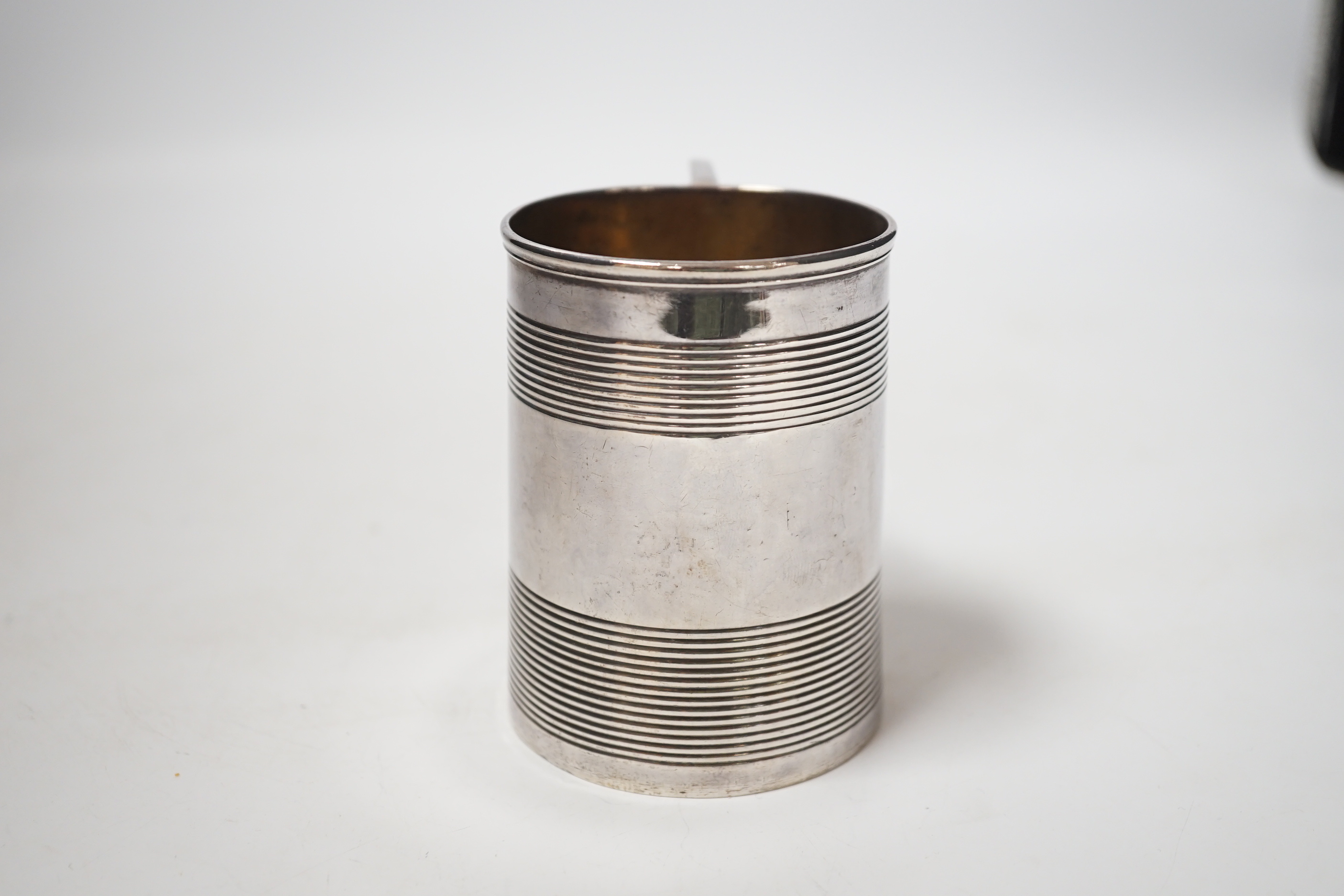 A George III reeded silver christening mug, Stephen Adam I, London, 1801, 85mm.